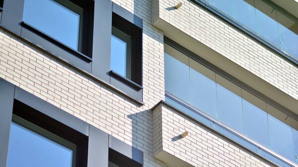 Modern apartment building on a sunny day. Architectural details and facade of a modern apartment building.