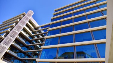 A modern corporate hub in the city center. The structure features a glass and concrete walls, showcasing contemporary architecture. Modern luxury office building.