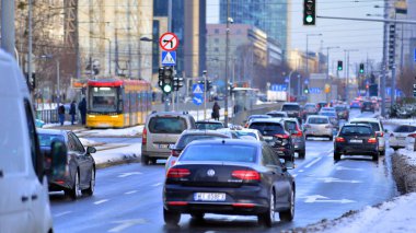 Varşova, Polonya. 5 Ocak 2026. Kış günü şehir merkezinde yol trafiği. Şehir merkezindeki trafik, binalar ve gökdelenlerle dolu bir caddeyi bir kış günü görmek.