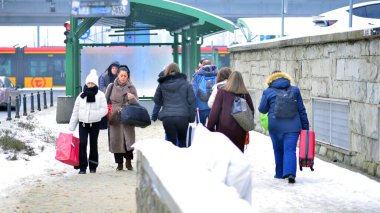 Varşova, Polonya. 15 Ocak 2026. Soğuk bir kış gününde şehirde sokakta yürüyen insanlar var. Kalabalık kalabalık caddede yürüyen isimsiz insanlar. Şehir sokak hayatı.