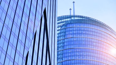 Çelik ve camdan yapılmış modern ofis binası. Ofis binasının pencereleri. Güneş ışığıyla soyut mimari kavram.