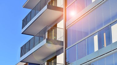Kentsel yaşam ve modern mimari kavramı. Camdan balkonları ve beyaz cepheli modern apartman manzarası. Avrupa 'da çağdaş apartman binası.
