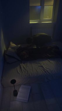 Öfkeli adam umutsuzluk içinde yatağa düşüyor, duygusal çöküntü ve karanlık yatak odasında umutsuzluk. Başarısızlık, öfke ve depresyon kavramı.