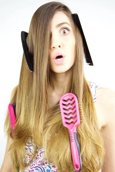 Girl making funny faces having trouble with long hair — Stock Photo, Image