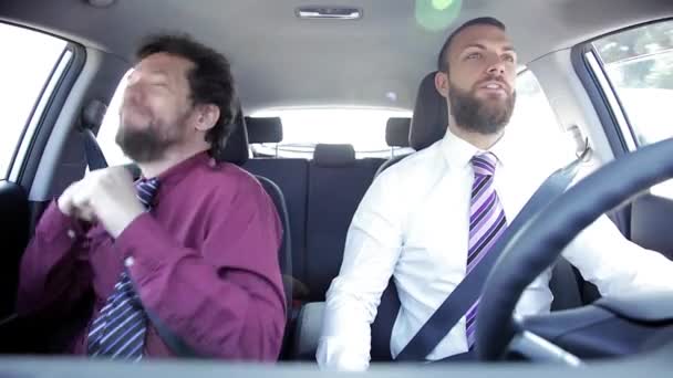 Two happy funny business men dancing in car — Stock Video