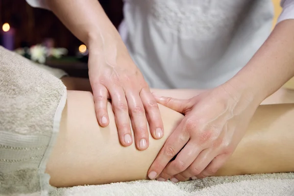 Side view of a woman legs receiving a massage — Stock Photo, Image