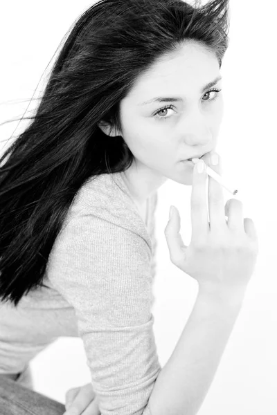 Black and white portrait of young sad woman smoking Stock Image