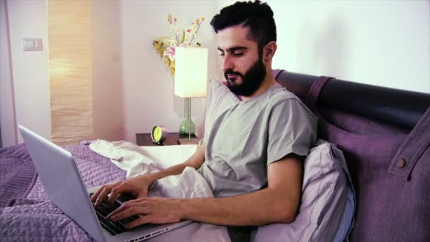 Happy young man in bed — Stock Video