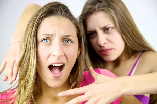 Angry girl willing to strangle blond screaming friend — Stock Photo, Image