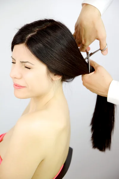 Woman scared about getting long hair cutter for new hairstyle — Stock Photo, Image