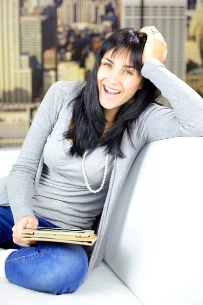 Happy smiling young woman at home in city holding tablet — Stock Photo, Image