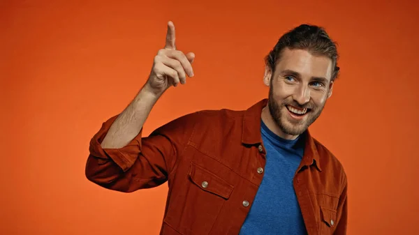Positive Young Bearded Man Smiling While Pointing Finger Orange — Stock Photo, Image
