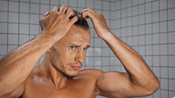 Muscular Man Adjusting Hair Bathroom — Stock Photo, Image