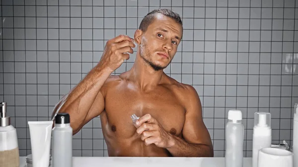 Shirtless Man Holding Bottle Applying Serum Bathroom — Stock Photo, Image