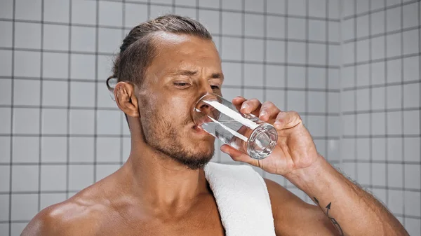 Uomo Senza Camicia Acqua Potabile Mentre Tiene Vetro Bagno — Foto Stock