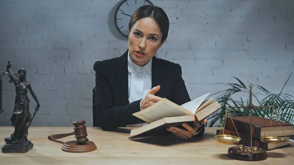 Insurance Agent Looking Camera While Holding Book Statuette Justice Gavel — Stock Photo, Image