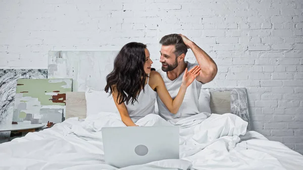 Excited Couple Looking Each Other While Watching Film Computer Bed — Stock Photo, Image