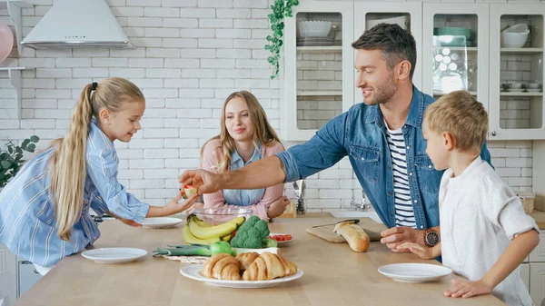 Father Giving Baguette Daughter Family Kitchen — Stock Photo, Image