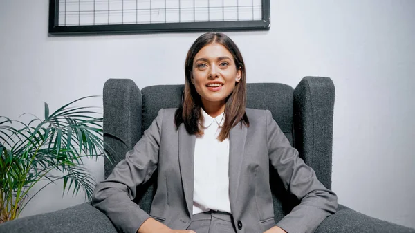 Smiling Businesswoman Sitting Armchair Plant Office — Stock Photo, Image