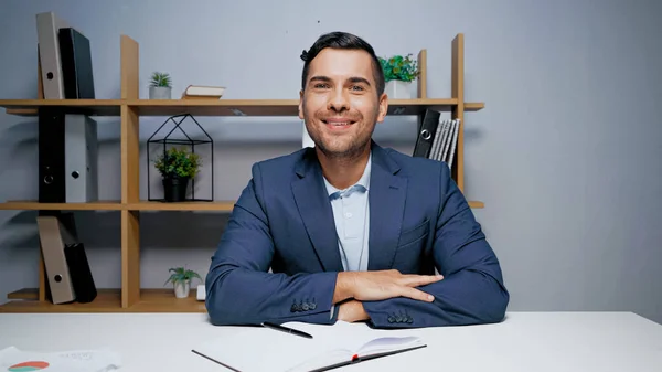 Businessman Looking Camera Copybook Pen Papers Blurred Foreground Table — Stock Photo, Image