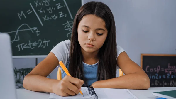 Upset Kid Writing Notebook While Doing Homework — Stock Photo, Image