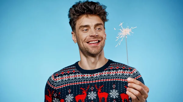 Smiling Man Sweater Looking Sparkler Blue Background — Stock Photo, Image