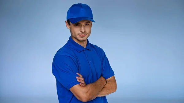 Confident Delivery Man Standing Crossed Arms Isolated Blue — Stock Photo, Image
