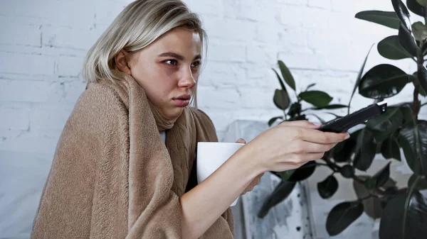 Sick Woman Holding Cup Warm Beverage While Clicking Channels Bedroom — Stock Photo, Image