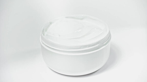 jar with moisturizing cosmetic product on white 
