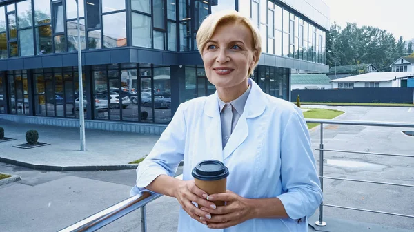 Smiling Doctor White Coat Holding Coffee Outdoors — Stock Photo, Image