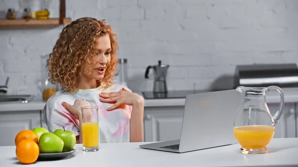 Curly Young Woman Pointing Herself While Talking Video Call Kitchen — Stock Photo, Image