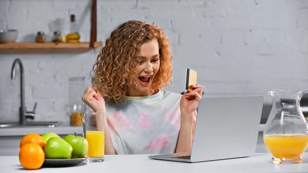 Excited Young Woman Holding Credit Card While Shopping Online Kitchen — Stock Photo, Image