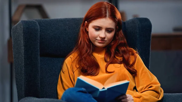 Teenager Reading Book Blurred Foreground Armchair — Stock Photo, Image