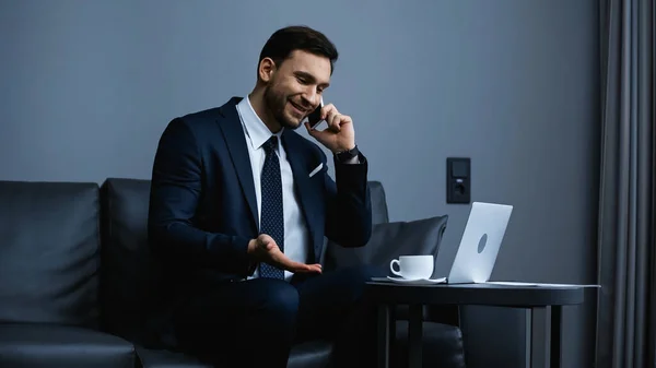 Smiling Businessman Talking Smartphone Laptop Coffee Hotel Room — Stock Photo, Image