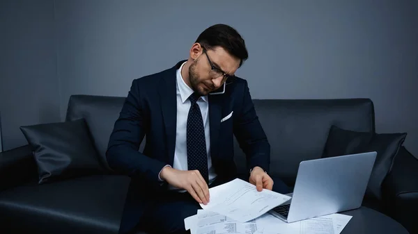 Businessman Talking Cellphone While Working Papers Laptop Hotel Room — Stock Photo, Image