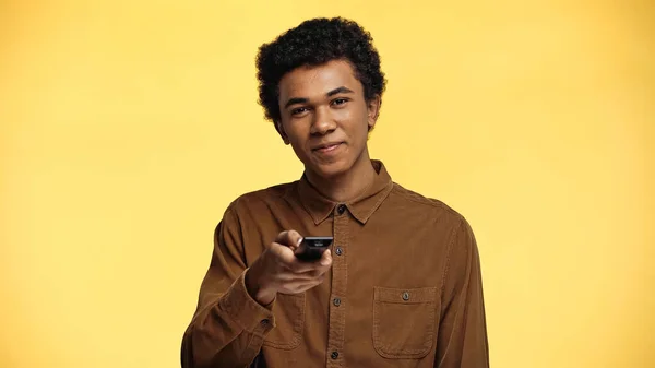 Cheerful African American Teenage Boy Holding Remote Controller Isolated Yellow — Stock Photo, Image