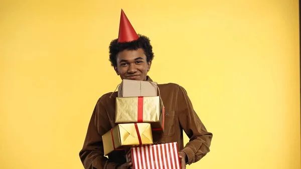 Smiling African American Teenager Party Cap Holding Gift Boxes Isolated — Stock Photo, Image