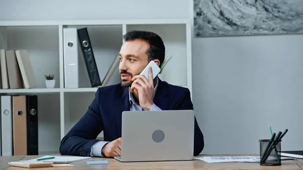 Businessman Talking Smartphone Laptop Papers Table — Stock Photo, Image