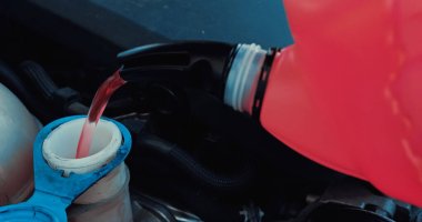 engine oil pouring from canister into motor of car clipart