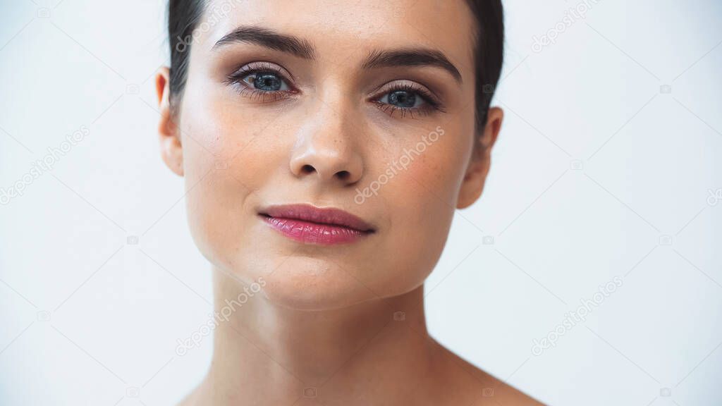 portrait of young woman with perfect face looking at camera isolated on white