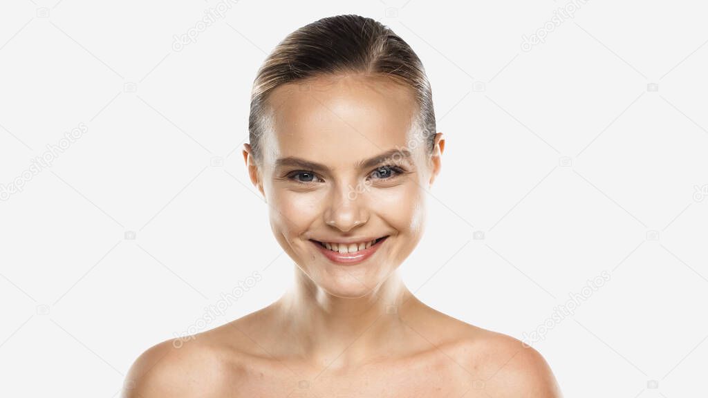 happy young woman with naked shoulders looking at camera isolated on white