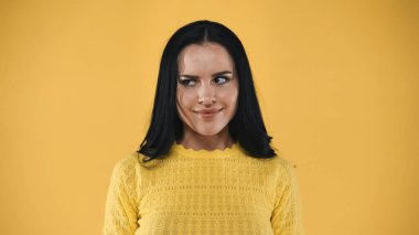 envy, brunette woman looking away isolated on yellow clipart