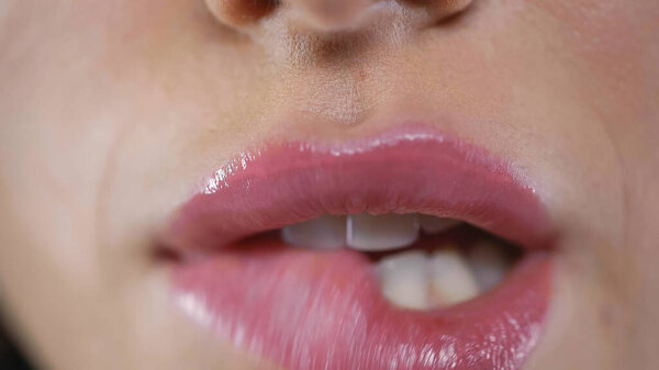  cropped view of seductive woman biting pink lip