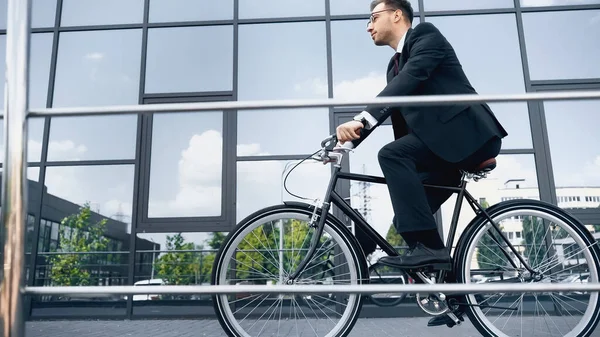 Full Length Businessman Suit Glasses Riding Bike Building Glass Facade — Stock Photo, Image