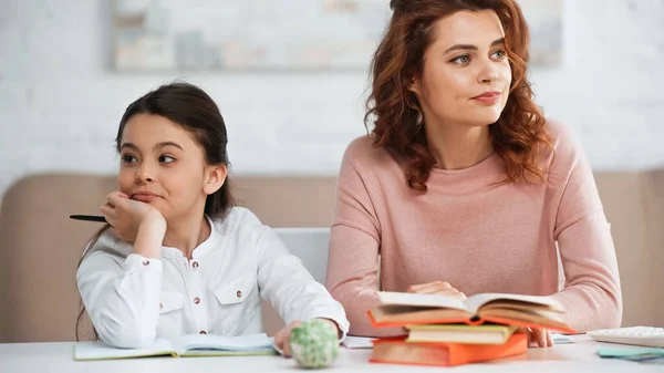 Displeased Daughter Mother Looking Away Books Table — Stock Photo, Image