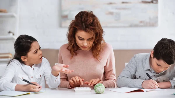 Flicka Pekar Med Handen Nära Mor Med Hjälp Miniräknare Och — Stockfoto