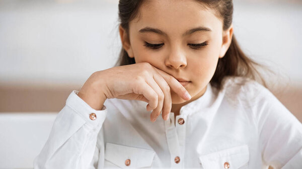 Girl in white shirt looking away 