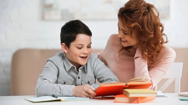 Positive Boy Reading Book Mother Home — Stock Photo, Image