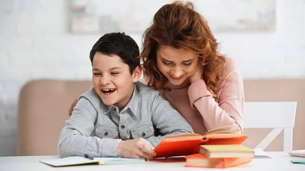 Smiling Woman Sitting Cheerful Son Holding Book Blurred Foreground — Stock Photo, Image