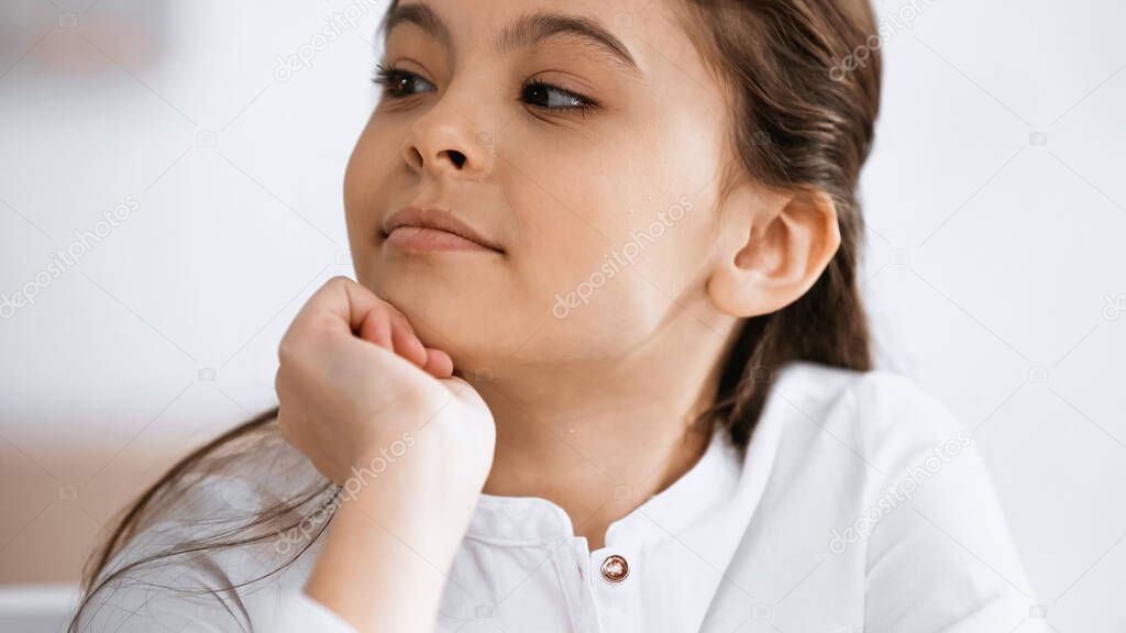 Preteen girl looking away at home 